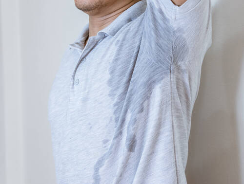 Rear view man standing against white wall