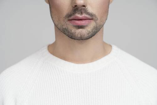 Half portrait queer person white blouse