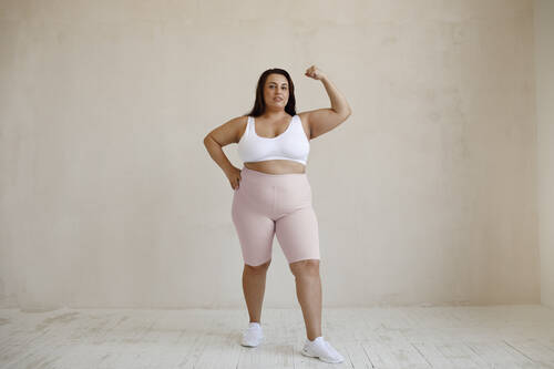 Full shot plus size model posing studio