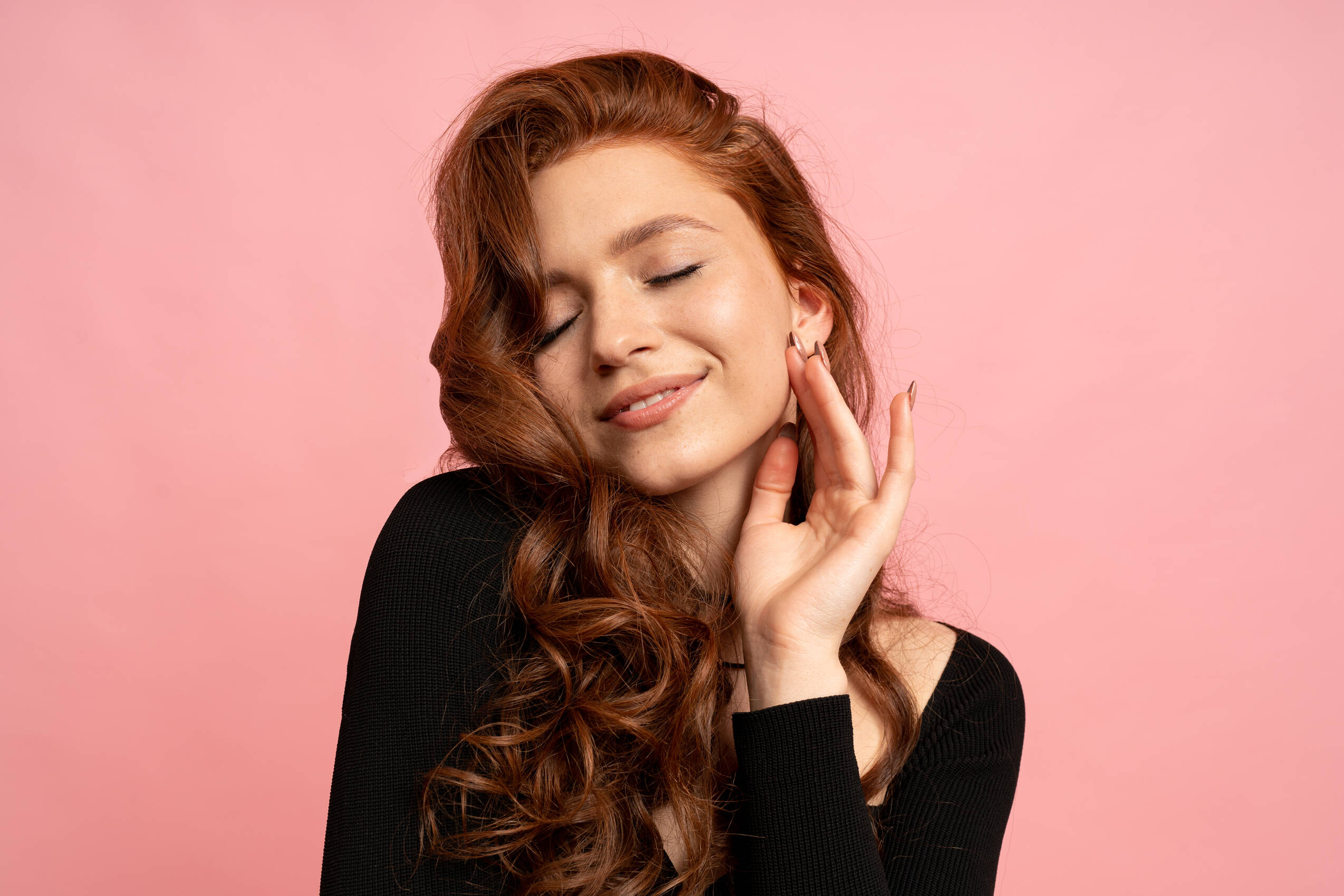 Beauty portrait red head woman posing pink wall wavy hairs perfect smile