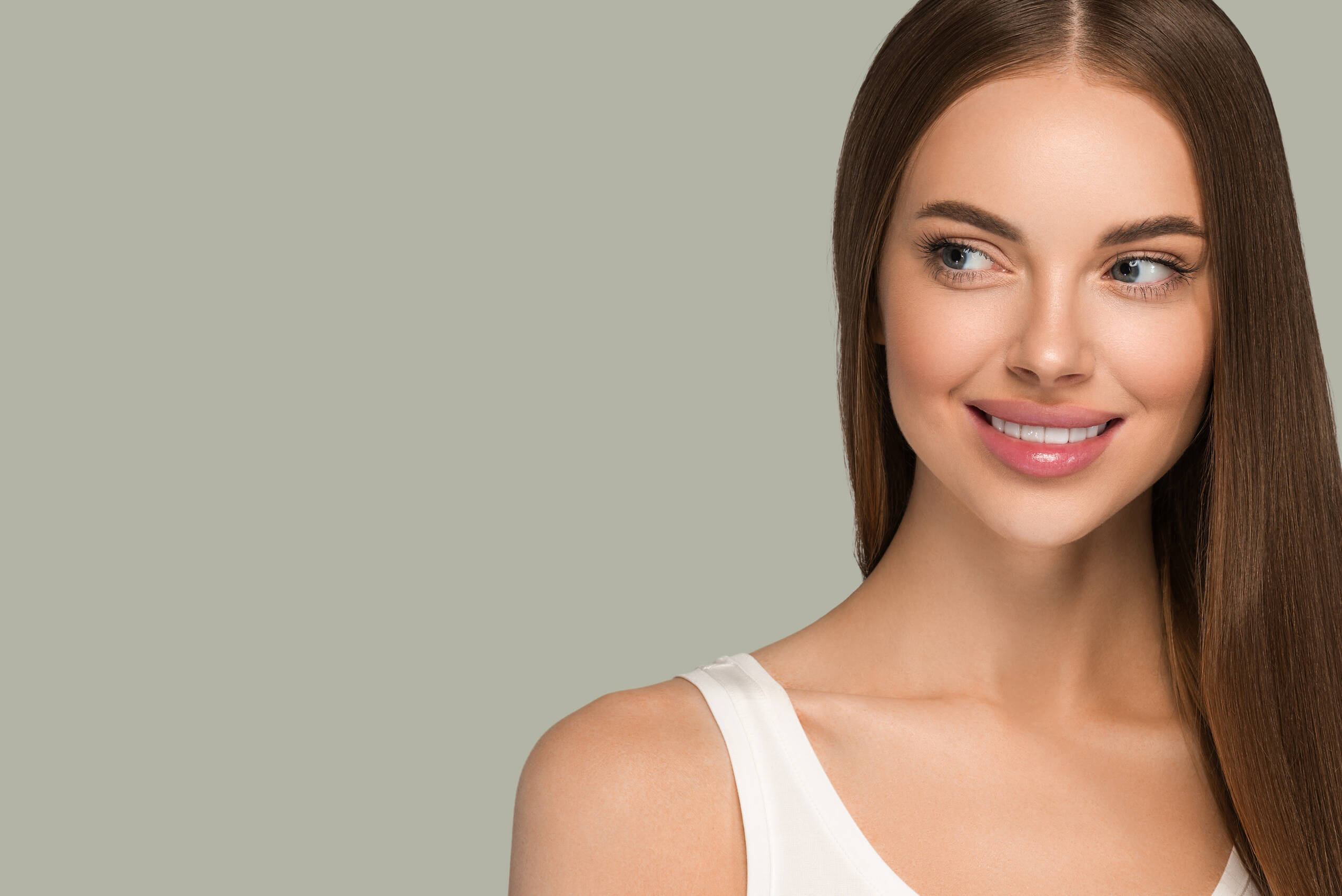 Beautiful woman with long healthy smooth hair beauty natural casual style color background green