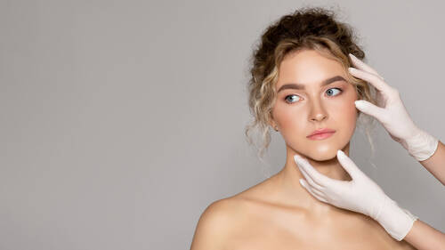 Beautiful lady getting treatment cosmetology clinic plastic surgeon touching female face panorama with free space