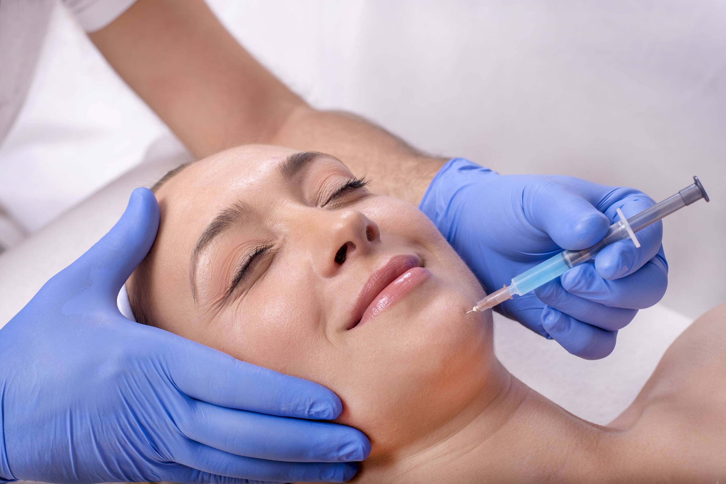 Young beautiful caucasian female treatment with hyaluronic acid beauty clinic