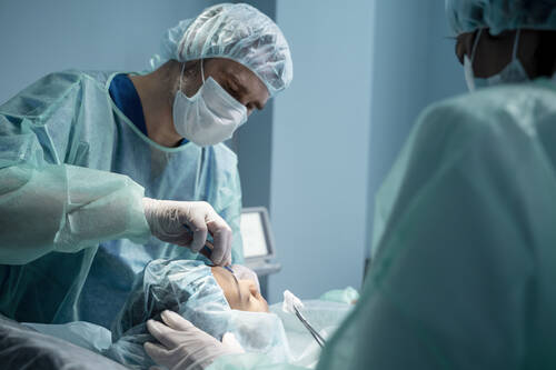 Doctors performing rhinoplasty operating room